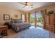 Comfortable main bedroom with decorative rug, ceiling fan, and backyard views at 5336 E Gloria Ln, Cave Creek, AZ 85331