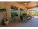 A relaxing outdoor patio area with a ceiling fan, comfortable seating and beautiful desert views at 5336 E Gloria Ln, Cave Creek, AZ 85331