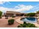 Backyard view featuring a private pool, covered patio, and beautifully xeriscaped grounds at 5536 E Gable Ave, Mesa, AZ 85206
