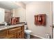 Bathroom features wood cabinets, granite countertops, and a large mirror above the sink at 5536 E Gable Ave, Mesa, AZ 85206
