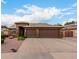 Charming single-story home featuring a three-car garage and desert landscaping at 5536 E Gable Ave, Mesa, AZ 85206