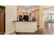 Eat-in kitchen featuring custom wood cabinetry, black appliances, and a breakfast bar for casual dining at 5536 E Gable Ave, Mesa, AZ 85206