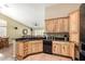 Well-appointed kitchen with wood cabinetry, granite counters, and an open layout to the living area at 5536 E Gable Ave, Mesa, AZ 85206