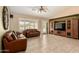 Bright living room with tile floors, comfortable seating, ceiling fan, and a media center at 5536 E Gable Ave, Mesa, AZ 85206