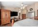 A luxurious main bedroom with tiled floors, private ensuite bathroom, and large-screen television at 5536 E Gable Ave, Mesa, AZ 85206