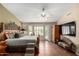 Large main bedroom with tiled floors, a tray ceiling, and an exit to the pool area at 5536 E Gable Ave, Mesa, AZ 85206