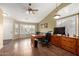 Home office showcasing tile floors, a ceiling fan, plantation shutters, and a built-in desk at 5536 E Gable Ave, Mesa, AZ 85206