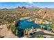 Breathtaking aerial view of the lake, surrounded by palm trees and desert landscape at 6055 E Vernon Ave, Scottsdale, AZ 85257