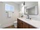 Beautiful bathroom with a vanity, white marble countertop, modern black hardware, and stylish light fixture at 6055 E Vernon Ave, Scottsdale, AZ 85257