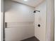 Tiled shower featuring modern fixtures and a built-in shelf with neutral tone at 6055 E Vernon Ave, Scottsdale, AZ 85257