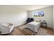 Bright bedroom features a twin bed, stylish area rug, and natural light from the beautiful outdoor view at 6055 E Vernon Ave, Scottsdale, AZ 85257
