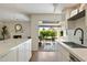Bright kitchen with marble countertops and stainless steel appliances, with view to living room and patio at 6055 E Vernon Ave, Scottsdale, AZ 85257