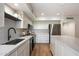 A bright kitchen featuring white cabinetry, stainless steel appliances, and modern countertops at 6055 E Vernon Ave, Scottsdale, AZ 85257
