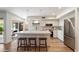 Modern kitchen with an island with bar stool seating and stainless steel appliances at 6055 E Vernon Ave, Scottsdale, AZ 85257