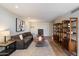 Comfortable living room featuring a sectional, decorative shelving, and stylish decor at 6055 E Vernon Ave, Scottsdale, AZ 85257