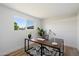 Bright home office with a large window, modern desk, and a patterned rug at 6055 E Vernon Ave, Scottsdale, AZ 85257