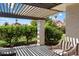 Relaxing outdoor patio with shaded pergola, mountain views, and lush landscaping at 6055 E Vernon Ave, Scottsdale, AZ 85257