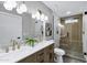 Modern bathroom featuring a double vanity, marble style walls, updated fixtures, and a glass enclosed shower at 6441 E Julep St, Mesa, AZ 85205
