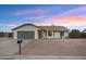 Charming single-story home with a well-maintained front yard, gray two car garage, and desert landscaping at 6441 E Julep St, Mesa, AZ 85205