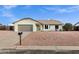 Charming single-story home with a well-maintained front yard, gray two car garage, and desert landscaping at 6441 E Julep St, Mesa, AZ 85205