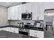 Updated kitchen featuring stainless steel appliances and white cabinets at 6441 E Julep St, Mesa, AZ 85205