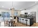 Modern kitchen boasts stainless steel appliances, a black countertop island, and adjacent dining area at 6441 E Julep St, Mesa, AZ 85205
