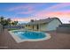 Backyard view of a pool with surrounding landscaping, a covered patio, and a neutral exterior paint scheme at 6441 E Julep St, Mesa, AZ 85205