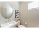 Half bath featuring a pedestal sink, an oval mirror, and natural light at 670 W Laredo St, Chandler, AZ 85225