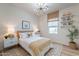 Bedroom featuring fun decor, white walls, a rattan bed frame and a large window at 670 W Laredo St, Chandler, AZ 85225