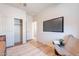 Neutral bedroom showcasing sleek floors, a mounted TV, and a cozy reading area with modern furnishings at 670 W Laredo St, Chandler, AZ 85225