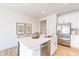 Bright, white kitchen with a large island with seating and stainless steel appliances at 670 W Laredo St, Chandler, AZ 85225