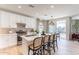 Bright, white kitchen with an island, seating, and stainless steel appliances at 670 W Laredo St, Chandler, AZ 85225