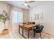 Bright home office with a wood desk, a ceiling fan, neutral walls, and a plaid rug at 670 W Laredo St, Chandler, AZ 85225