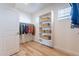 Walk-in closet featuring hardwood floors, a shelf for wicker baskets, and hanging racks at 670 W Laredo St, Chandler, AZ 85225