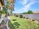 Manicured backyard with lush green grass, garden beds, and a desert view at 6914 W Juana Dr, Peoria, AZ 85383