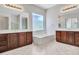 Spacious bathroom featuring double sinks and soaking tub under a bright window at 6914 W Juana Dr, Peoria, AZ 85383