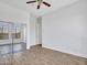 Bedroom featuring a mirrored closet, wood-look tile flooring, and neutral paint at 6914 W Juana Dr, Peoria, AZ 85383