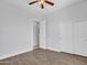 Bedroom featuring a ceiling fan, closet, and doorway to bathroom at 6914 W Juana Dr, Peoria, AZ 85383