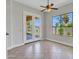 Bright dining area featuring tile floors, modern ceiling fan, and French doors to the outdoor space at 6914 W Juana Dr, Peoria, AZ 85383