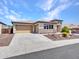 Single-Gathering home with tan exterior, stone accents, low maintenance landscaping, and a two car garage at 6914 W Juana Dr, Peoria, AZ 85383