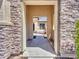 A glimpse through a stone-framed portal reveals a charming courtyard with a fountain at 6914 W Juana Dr, Peoria, AZ 85383