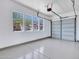 Spacious garage with epoxy flooring, white walls, and ample natural light from several windows at 6914 W Juana Dr, Peoria, AZ 85383