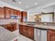Updated kitchen featuring rich cabinetry, granite countertops and stainless steel appliances with tile floors at 6914 W Juana Dr, Peoria, AZ 85383