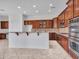 Updated kitchen with rich cabinetry, stainless steel appliances, granite countertops and breakfast bar at 6914 W Juana Dr, Peoria, AZ 85383
