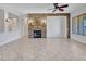 Inviting living room featuring a stone fireplace, ceiling fan, and tile flooring at 6914 W Juana Dr, Peoria, AZ 85383