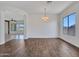 Spacious living room with tile floors, large window and adjacent dining area at 6914 W Juana Dr, Peoria, AZ 85383