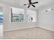 A living room featuring a ceiling fan and a view to the home's exterior through two cut-out squares at 6914 W Juana Dr, Peoria, AZ 85383