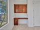 Office space featuring built-in cabinets, granite countertop desk, and a large window with view to the side yard at 6914 W Juana Dr, Peoria, AZ 85383