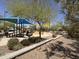 Shaded community playground features picnic benches and play structures at 6914 W Juana Dr, Peoria, AZ 85383