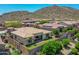 Beautiful home featuring a lush, green backyard with mountain views and desert landscaping at 6914 W Juana Dr, Peoria, AZ 85383